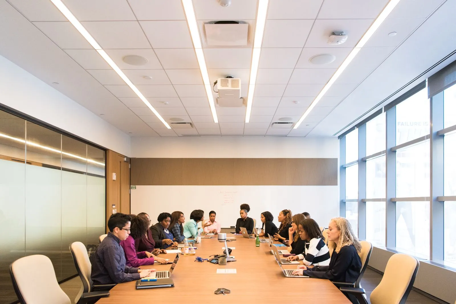 Team members gathered around a table in a conference room for a meeting