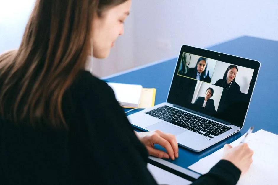 People collaborating on a video call from their laptops
