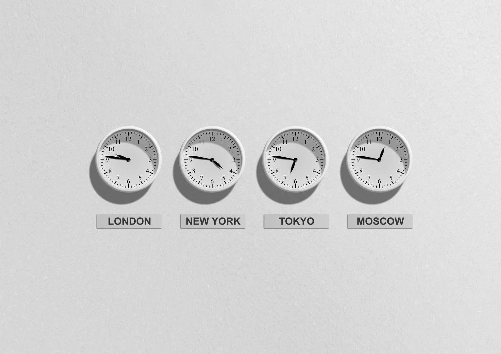 Analog wall clocks showing the current time in London, New York, Tokyo and Moscow